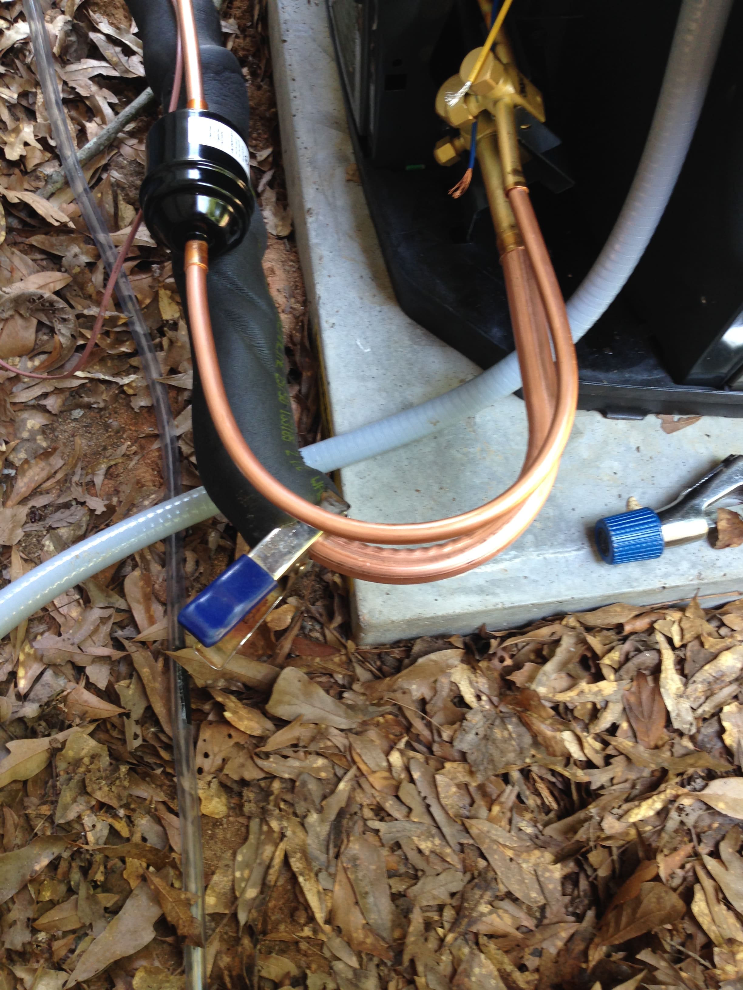 Refrigerant line and filter near AC unit
